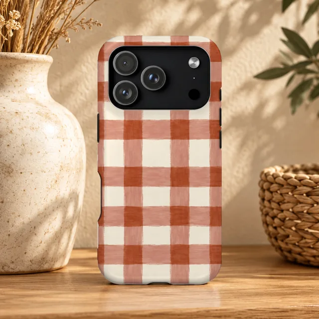 Phone case mockup next to a vase, terracotta gingham pattern